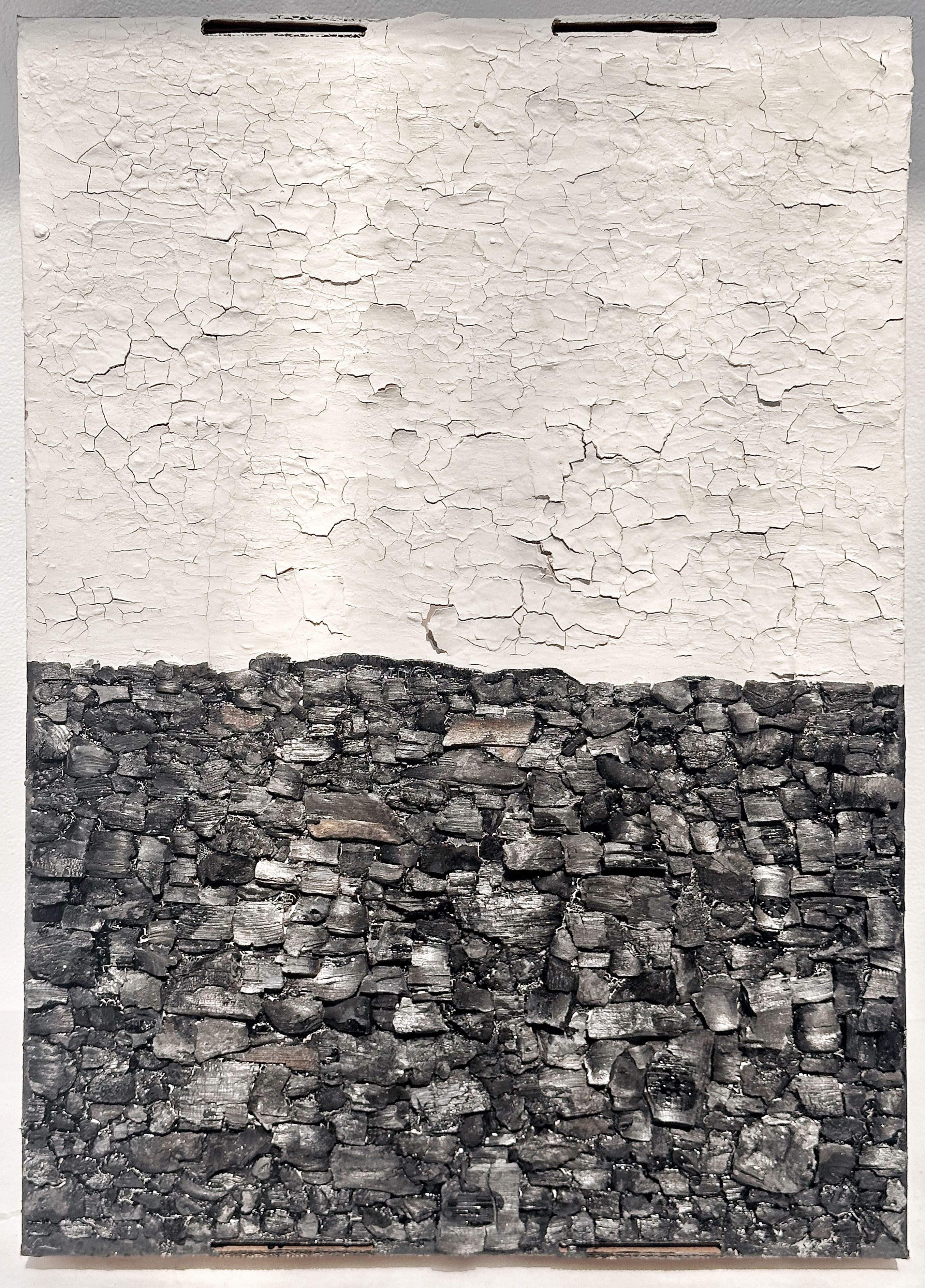 Charcoal 4, 2026. Assemblage：charcoal and clay on cardboard. Banff, Canada.